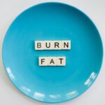 photo of a burn fat text on round blue plate