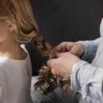 grandfather tying her granddaughter s hair