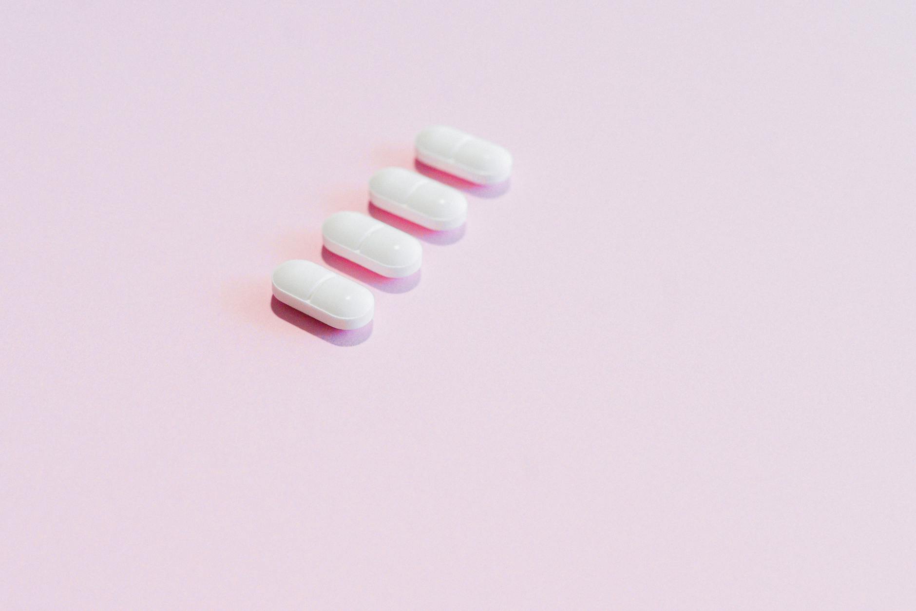 pills on a pink surface